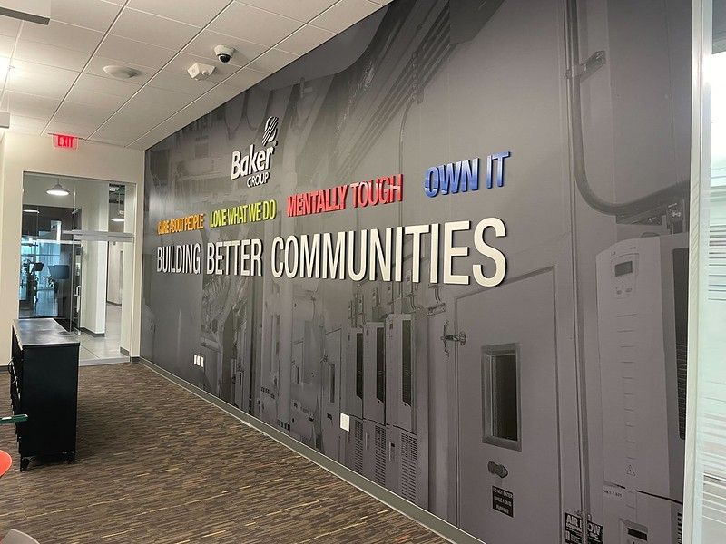 A wide wall mural features the text 