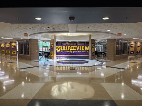 The back of a bright red work van, featuring the logo and website for 