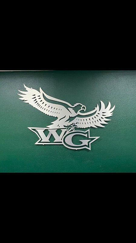 A silver-colored eagle graphic positioned above stylized 