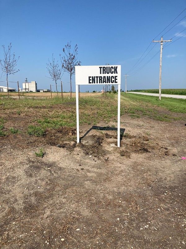 A white sign with black text reading 