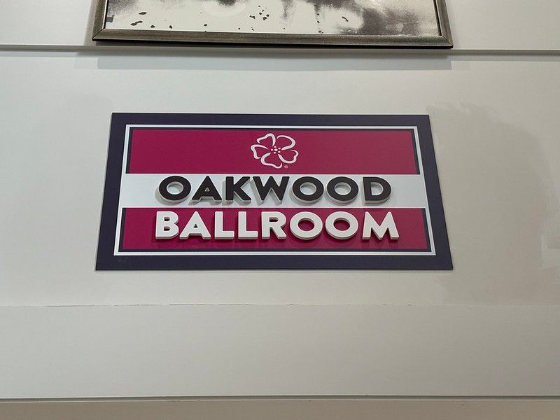 A sign on a white wall reads 