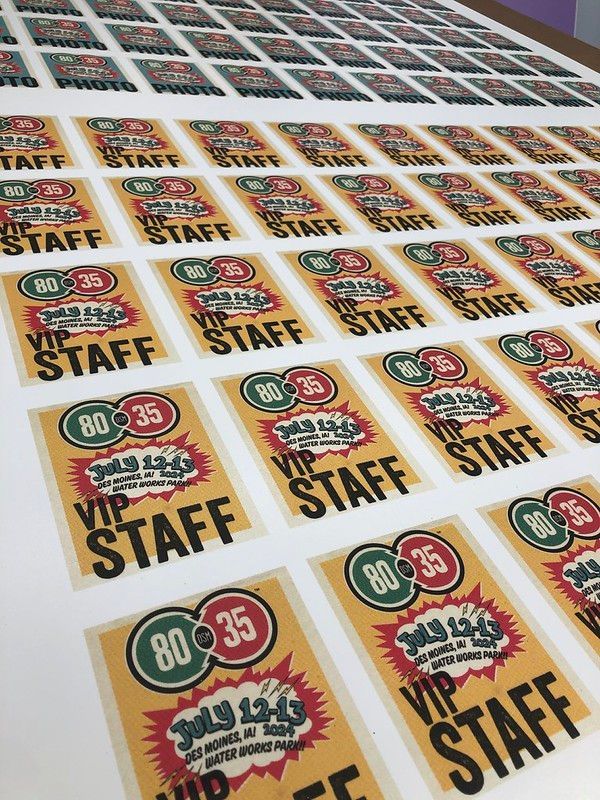 A sheet of printed rectangular stickers featuring “VIP STAFF” text, the dates “JULY 22-23,” and numbers 80 and 35.