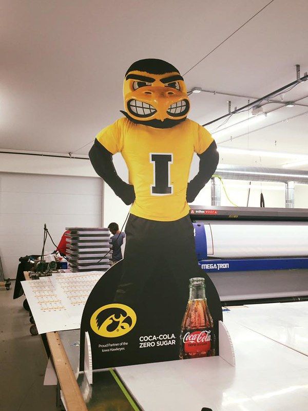 A cardboard cutout of the Iowa Hawkeyes mascot wearing a yellow 