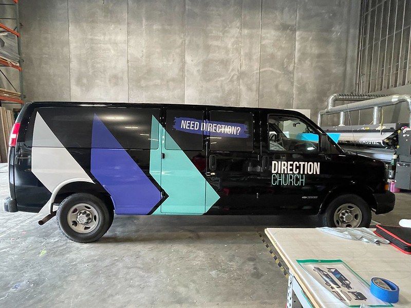 A black van parked indoors with a 