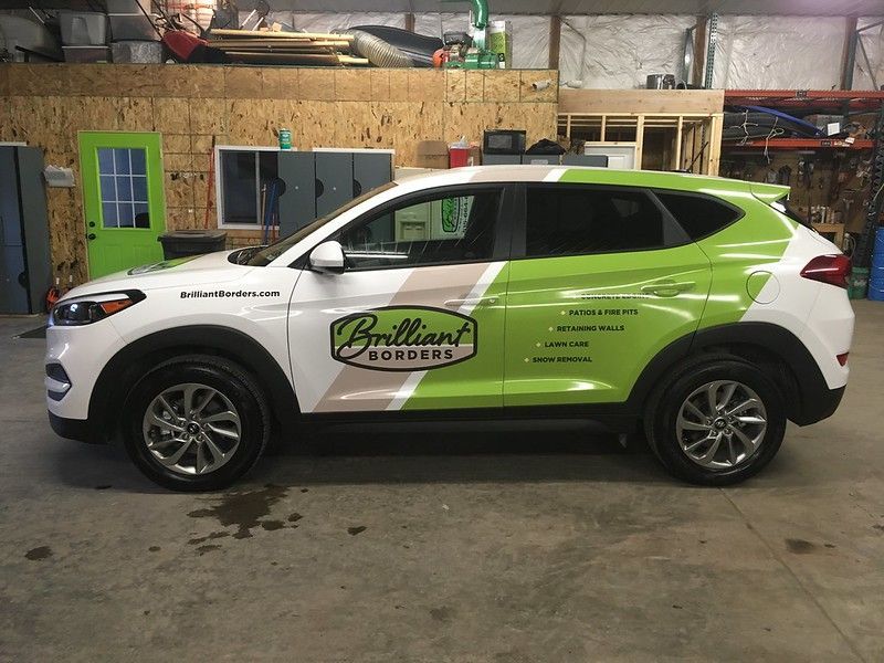 A white and lime green SUV branded with the 