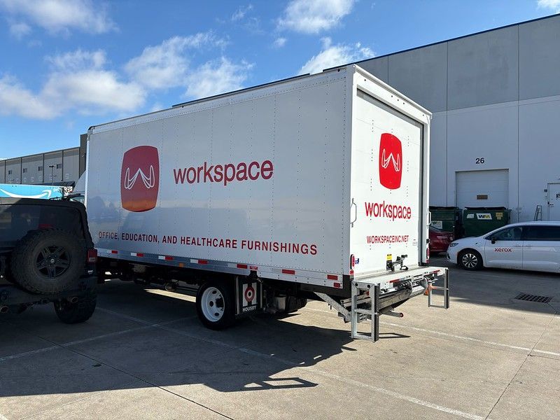 A white box truck with red 
