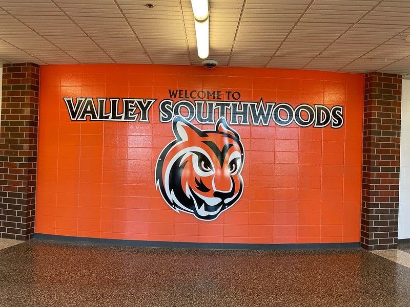 A bright orange wall with the text 