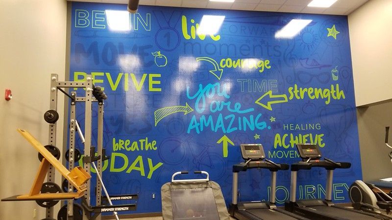 A gym wall with motivational words like 