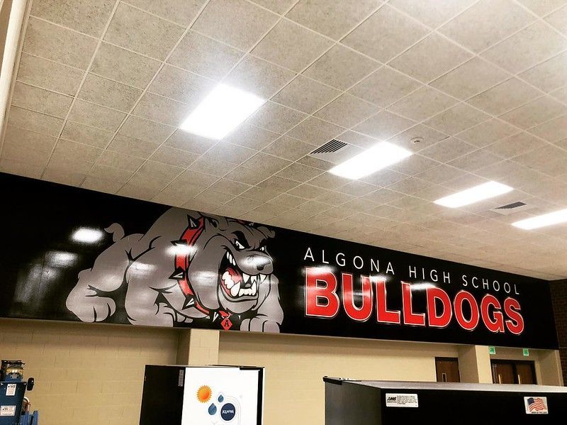 Wall mural of the Algona High School Bulldogs mascot—a gray bulldog—with red text on a black background.