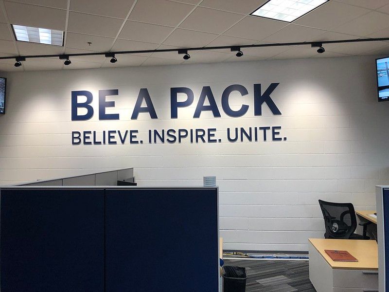 An office wall features the words 