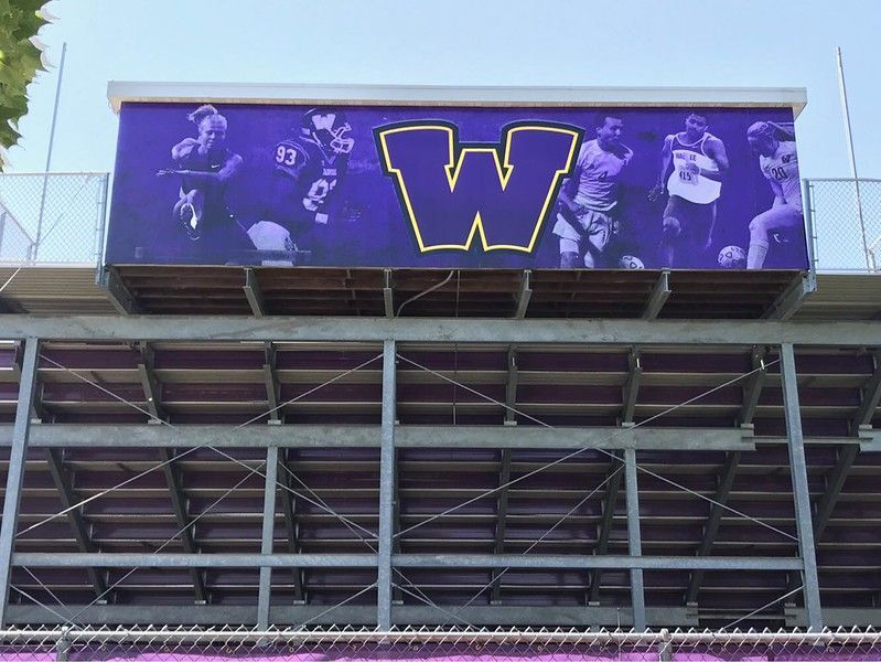 A purple banner with a large yellow 