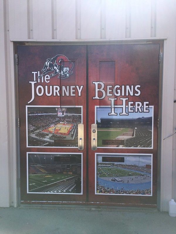 Double doors with a maroon background, text reading 