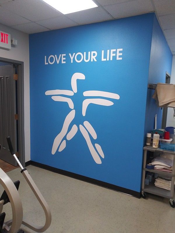 A bright blue wall in a room features the white text 