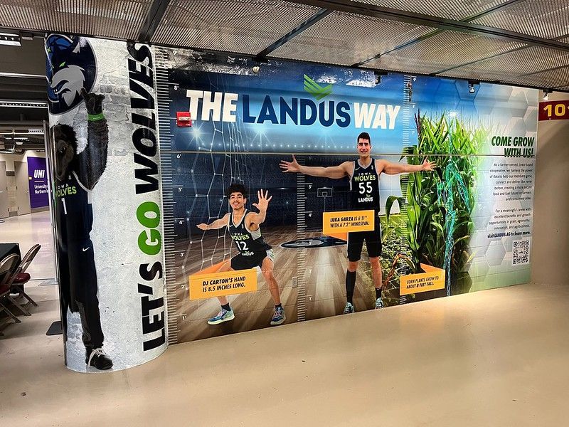 A mural in an arena tunnel featuring a mascot, basketball players, and 