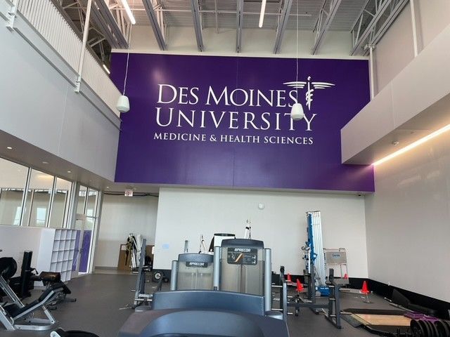 A purple sign reading 