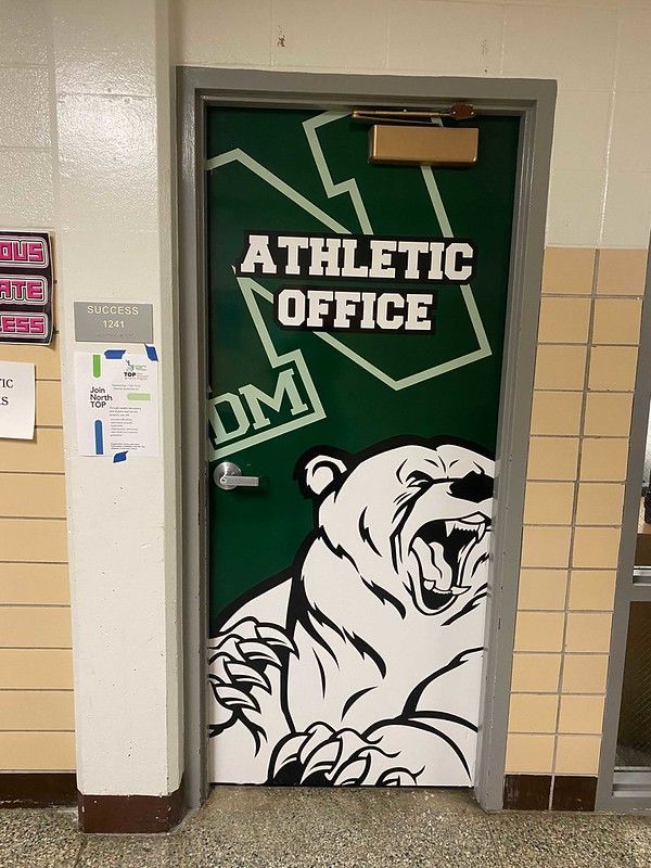 A green door labeled 