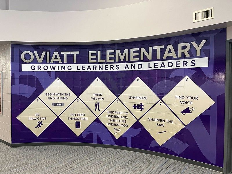 Wall mural at Oviatt Elementary featuring white diamonds with the 7 Habits of Highly Effective People against a purple wall.