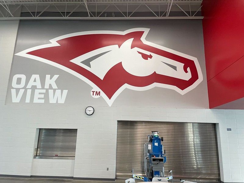 A red and white horse mascot logo and 