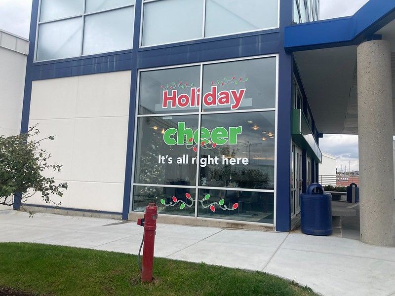 A building exterior with a window decal reading 