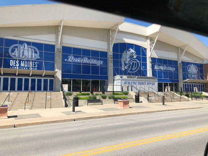 The Knapp Center in Des Moines, Iowa, featuring blue glass windows, university branding, and an outdoor ticket office.