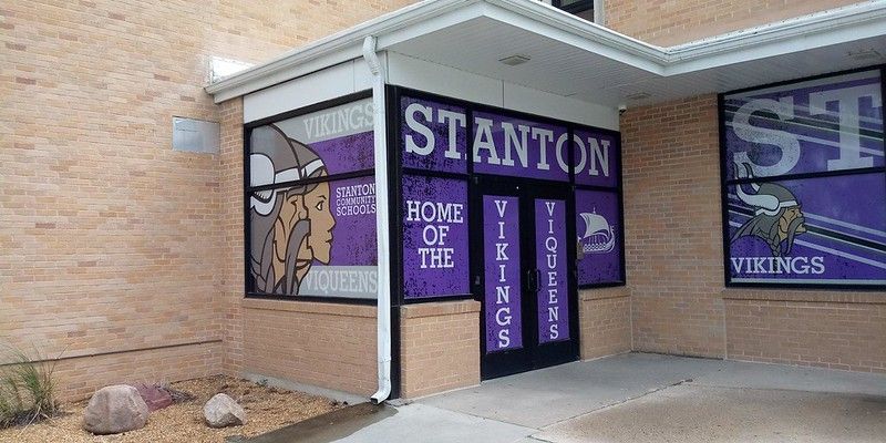 The brick entrance to Stanton School featuring purple window decals with the Viking mascot and the words 