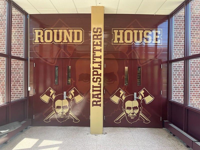 Maroon double doors labeled 