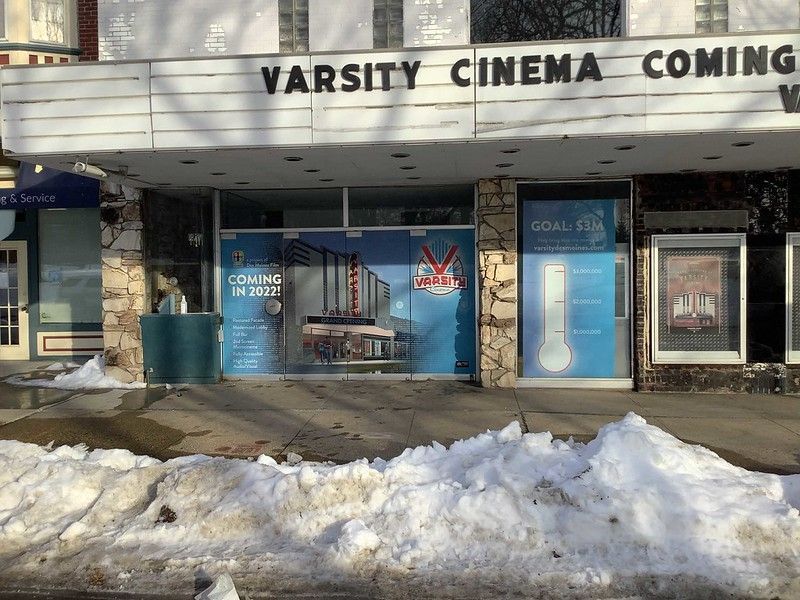 The Varsity Cinema building front with snowy ground and signage indicating upcoming renovations.