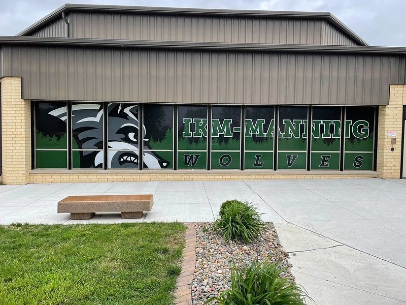 IKM-Manning school building featuring a large, stylized wolf mascot graphic and the text 