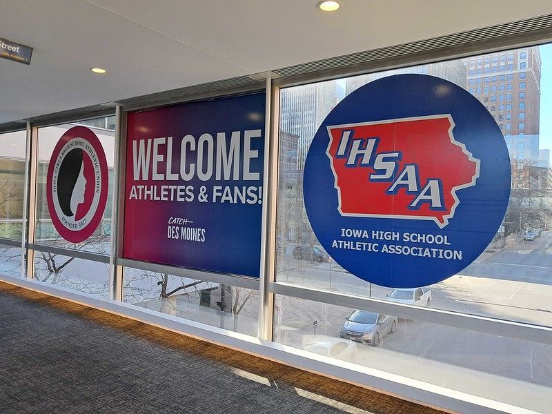 Window decals welcoming visitors to Des Moines with Iowa High School Athletic Association (IHSAA) branding.
