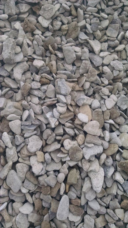 A pile of rocks is sitting on the ground.