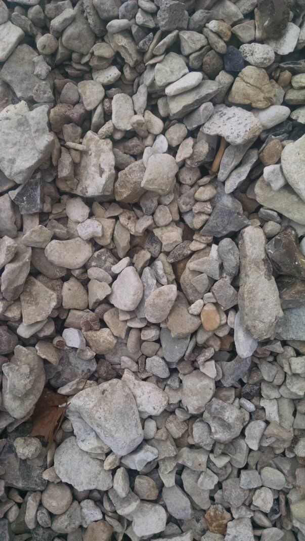 A pile of rocks sitting on top of each other on the ground.