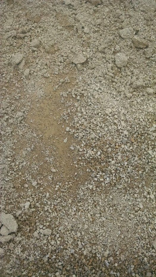 A pile of gravel and dirt on the ground.