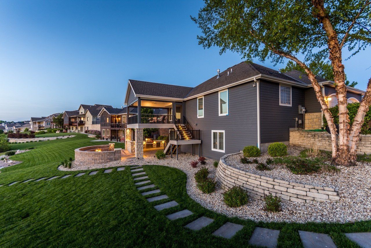 A large house with a large lawn in front of it.