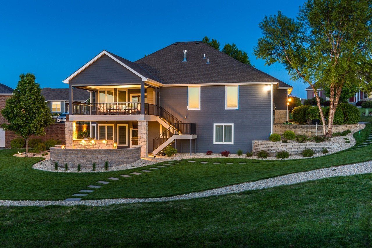 A large house with a lot of windows is lit up at night.