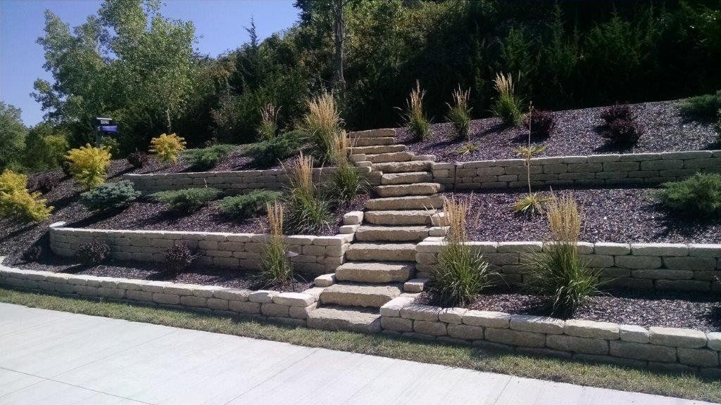 A set of stairs leading up to a lush green hillside