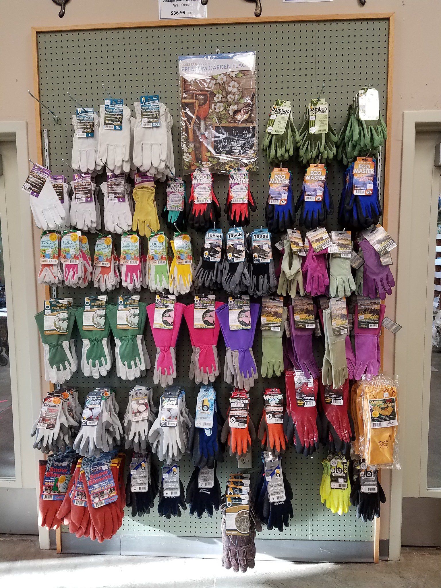 A wall filled with lots of different colored gloves