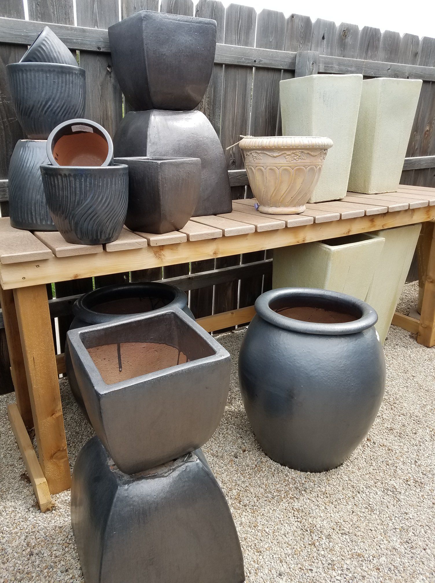 A wooden bench with a bunch of pots on it