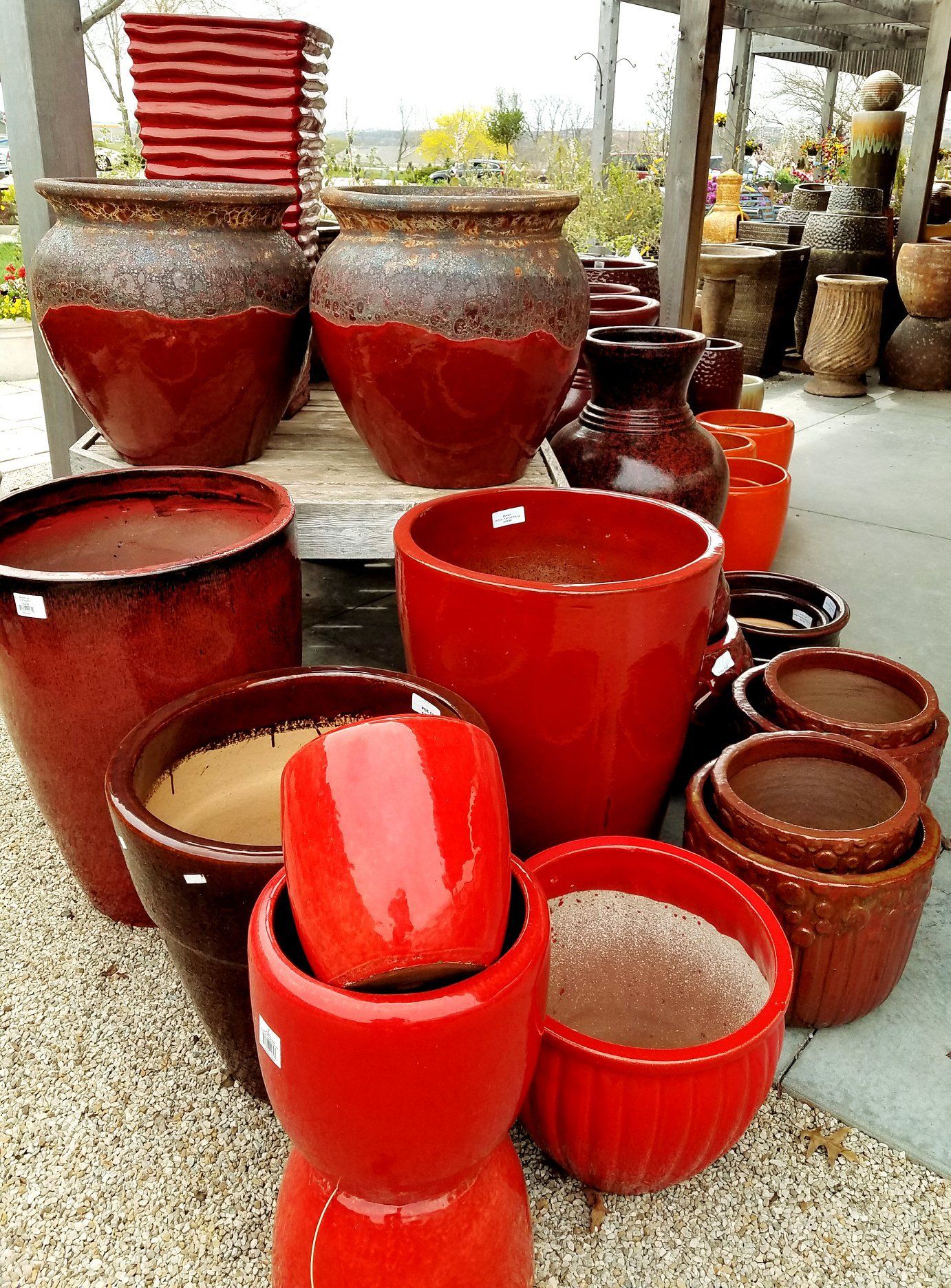 A bunch of red pots are stacked on top of each other