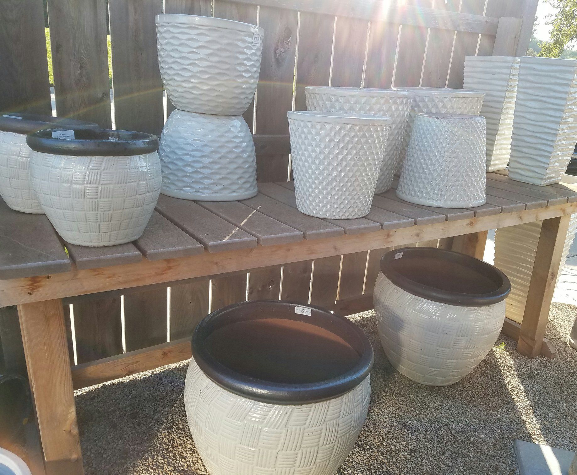 A wooden table with a bunch of pots on it