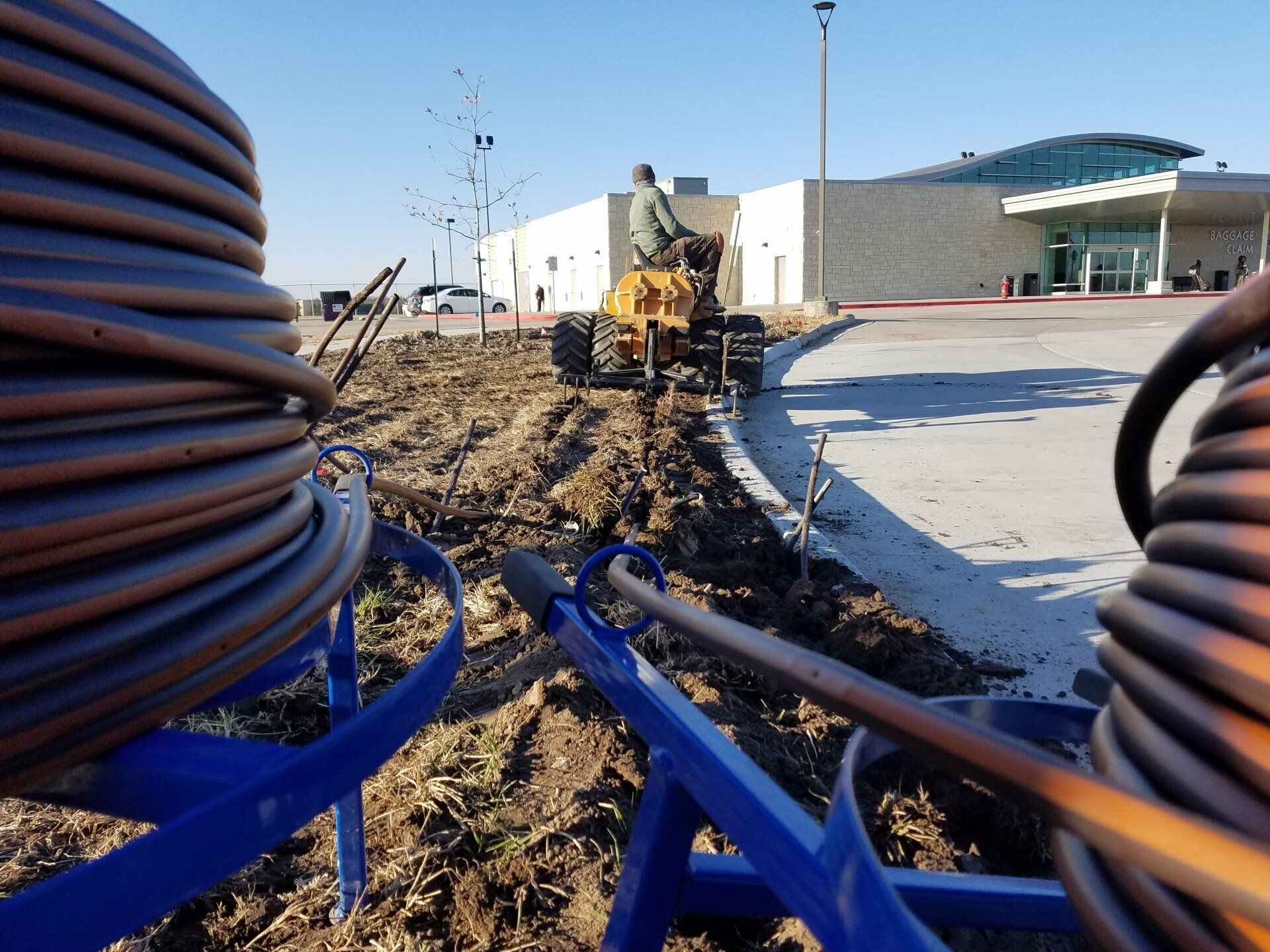 A man on a tractor is digging a hole in the ground