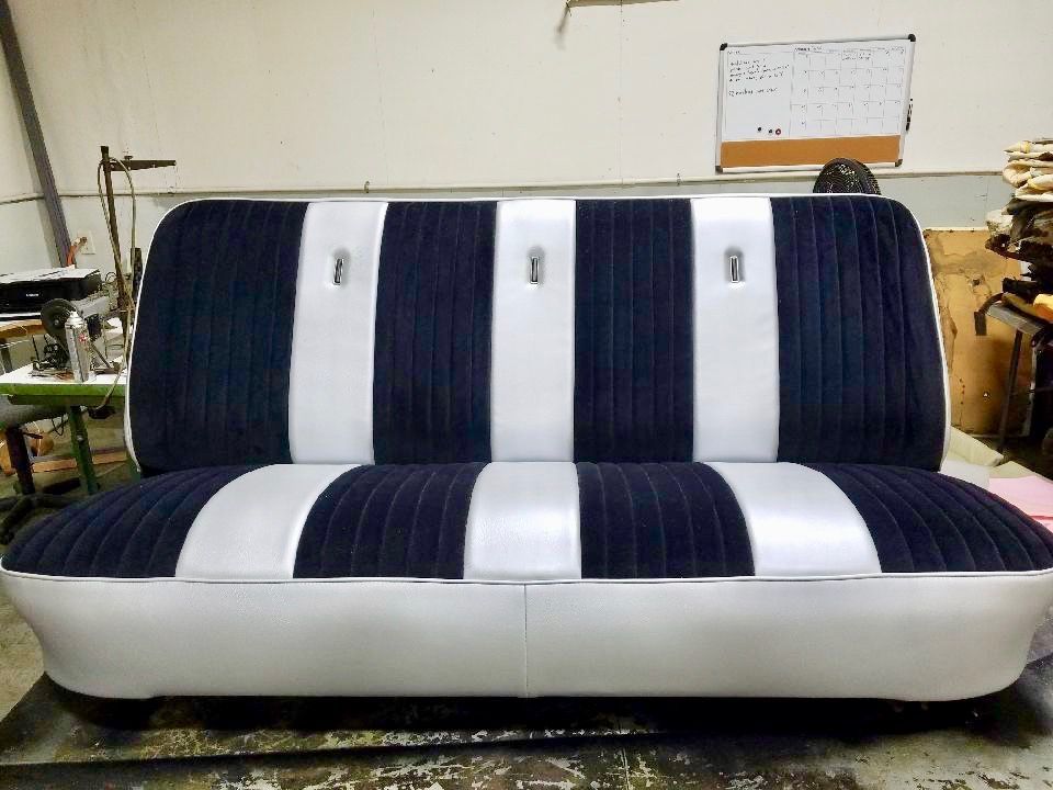 A black and white striped couch is sitting in a room