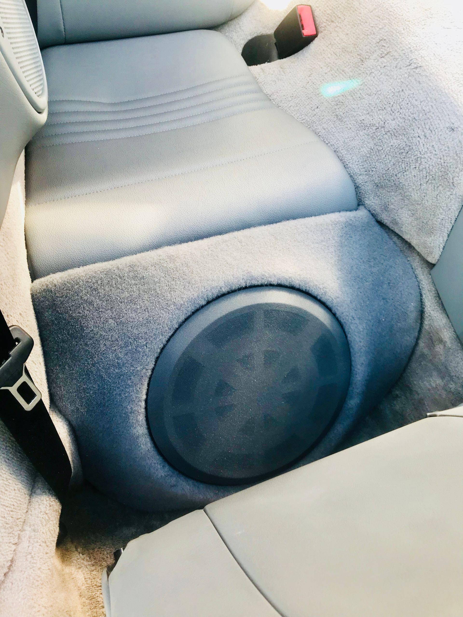 The back seat of a car has a speaker in it