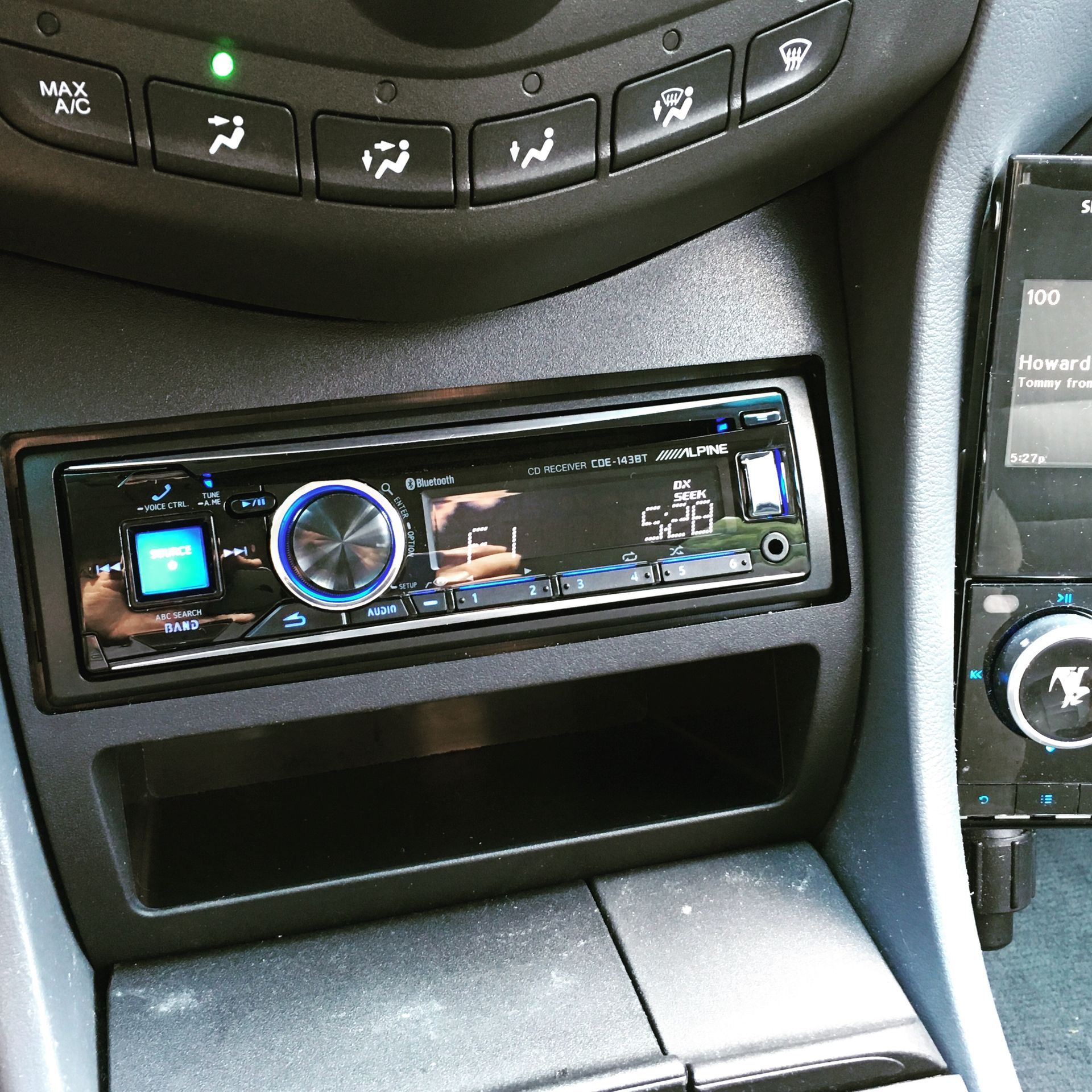 A car radio displays the time as 12:58