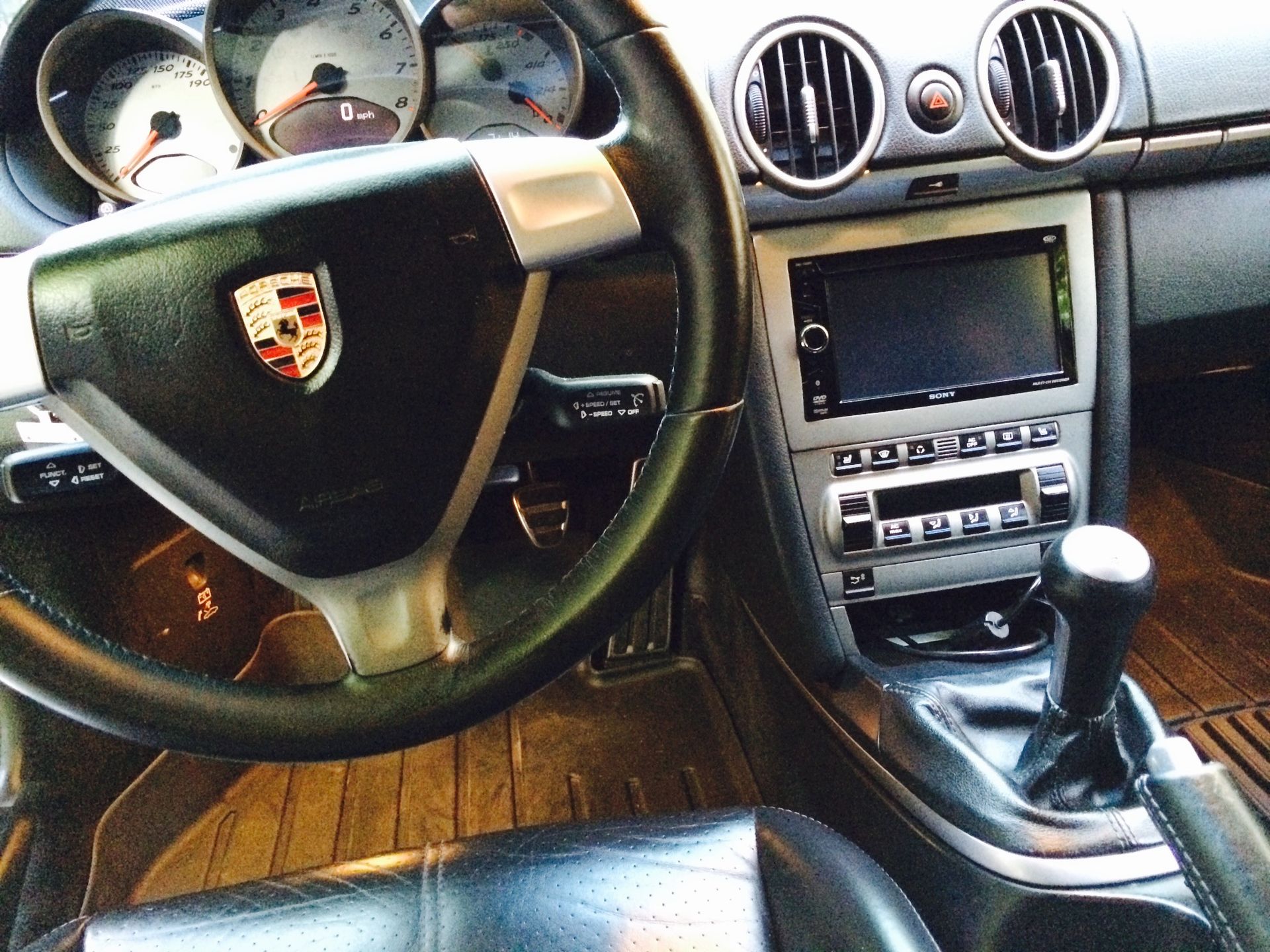 The interior of a Porsche car with a steering wheel