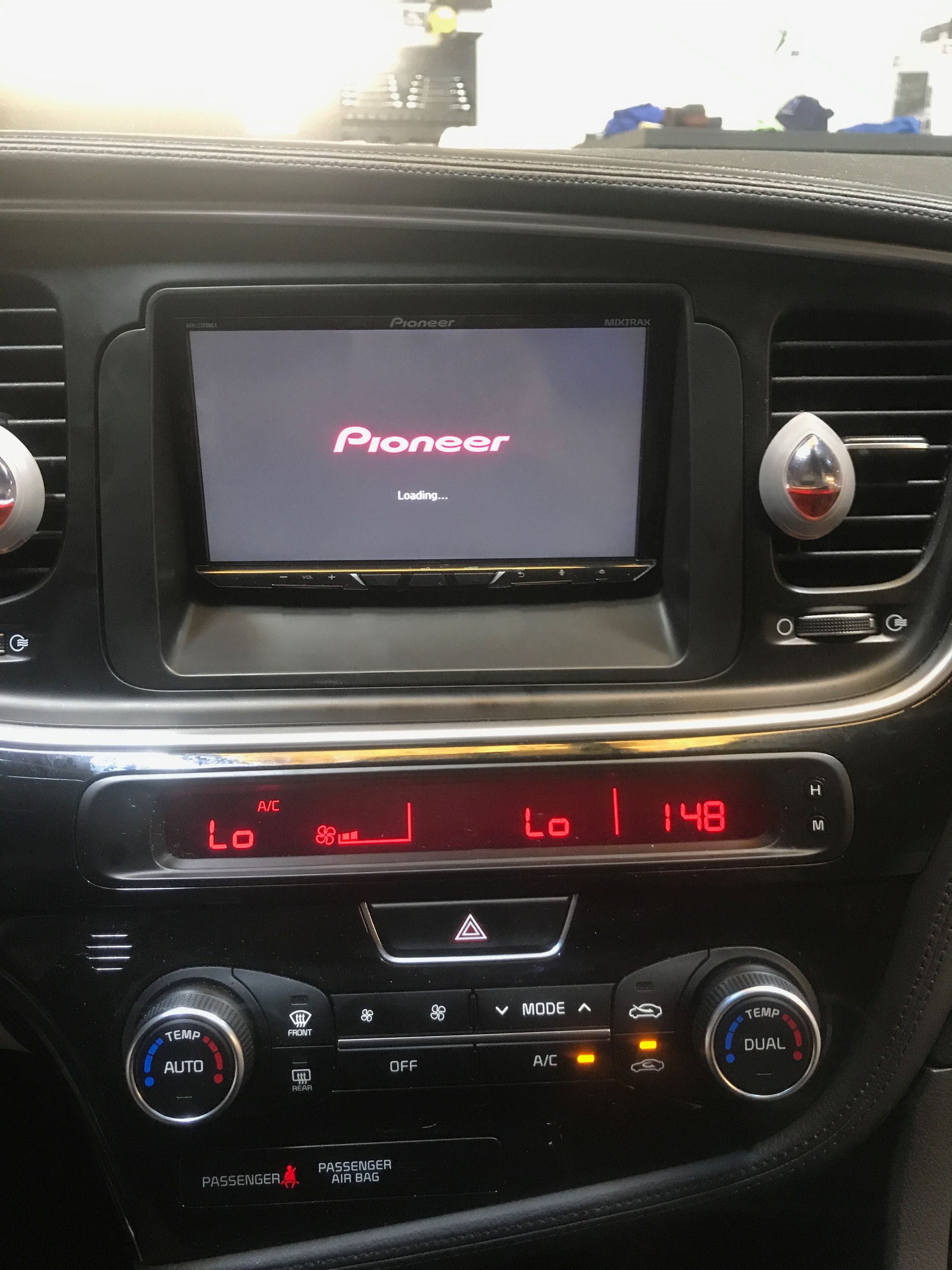 A car dashboard with a pioneer radio on it