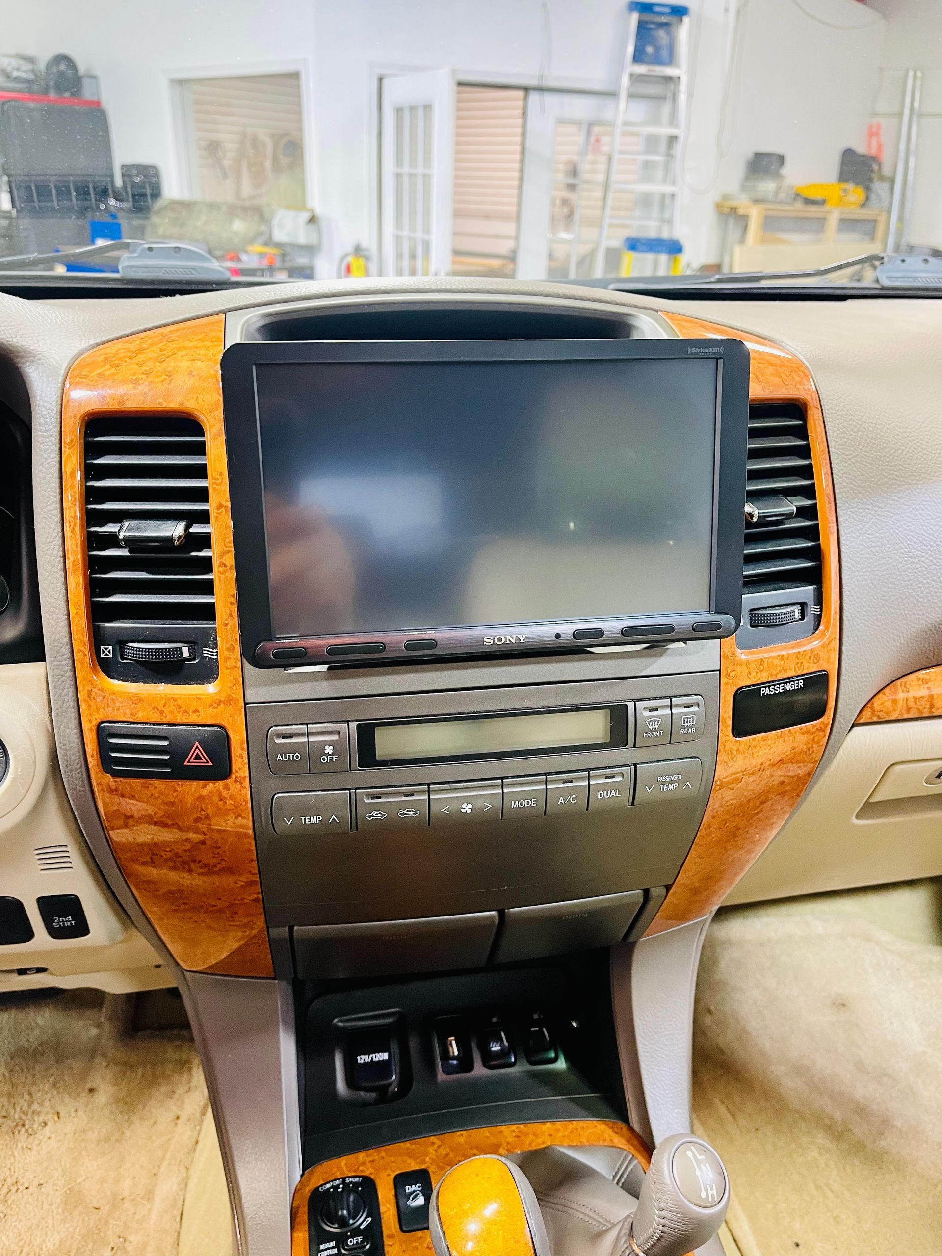 The dashboard of a car with a flat screen tv on it