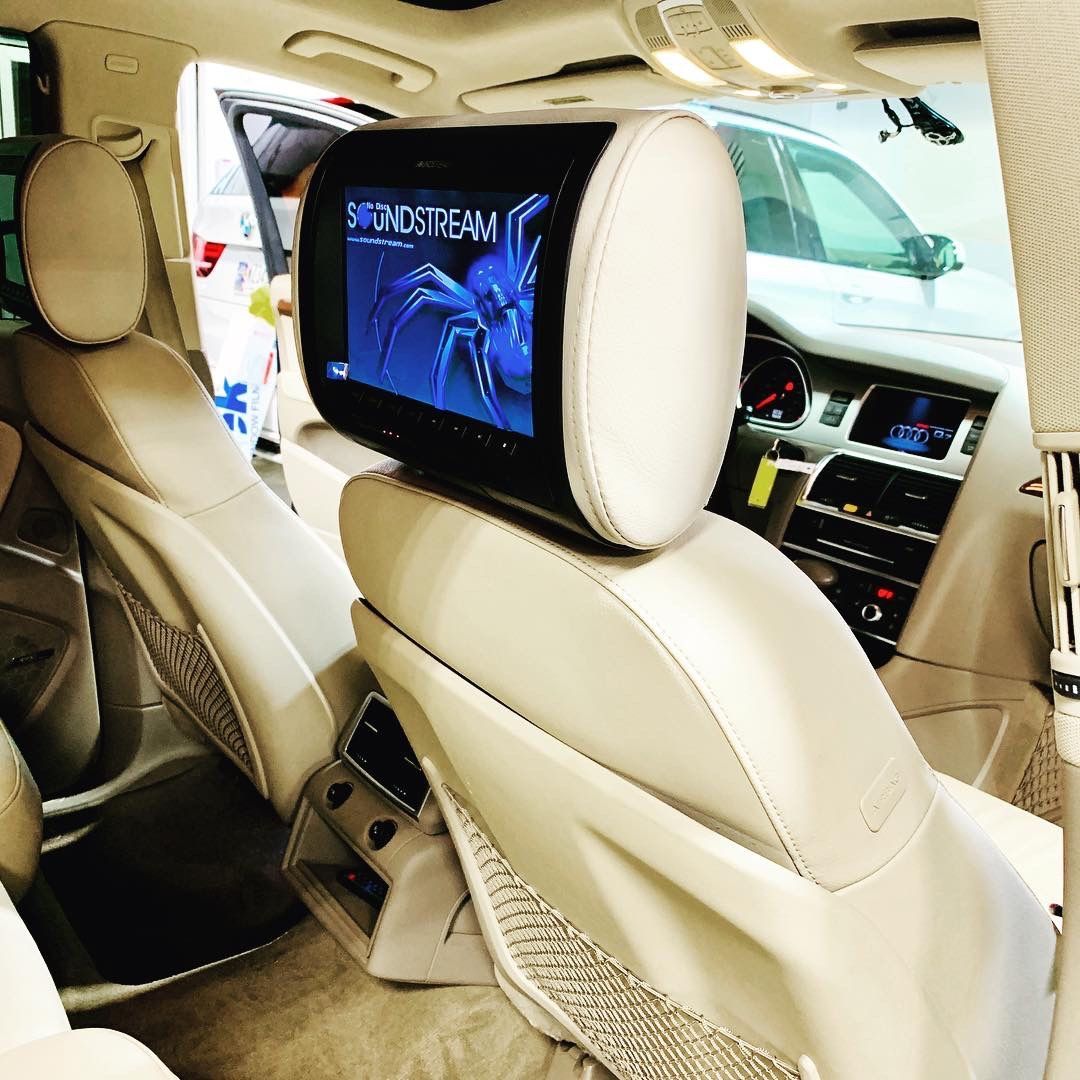 A car with a headrest monitor that says sharedream on it