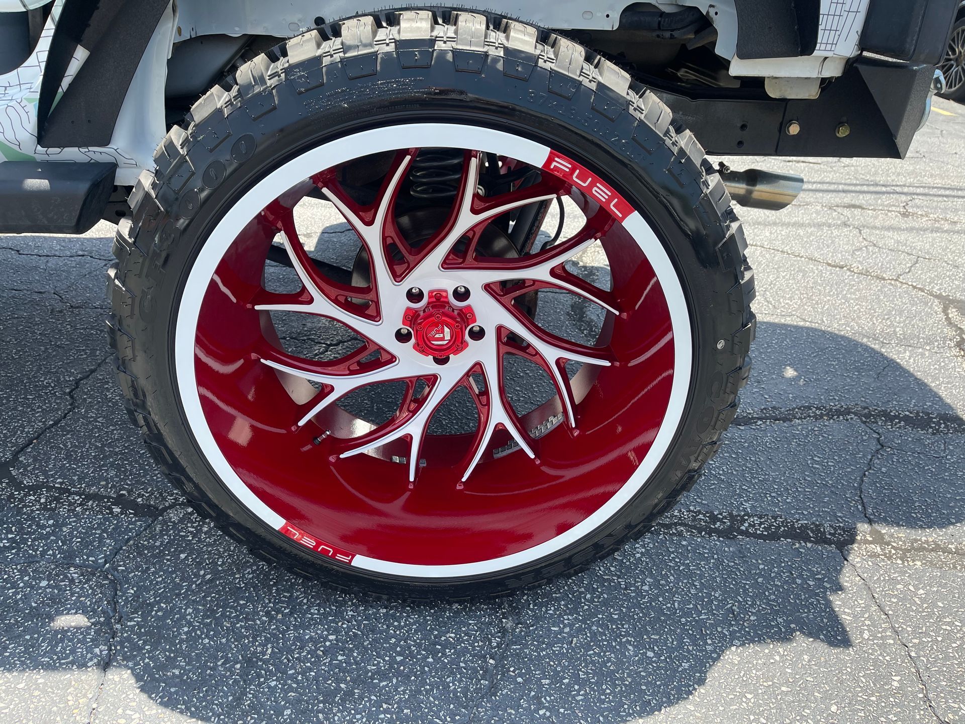 A close-up of a red and white wheel on a car.