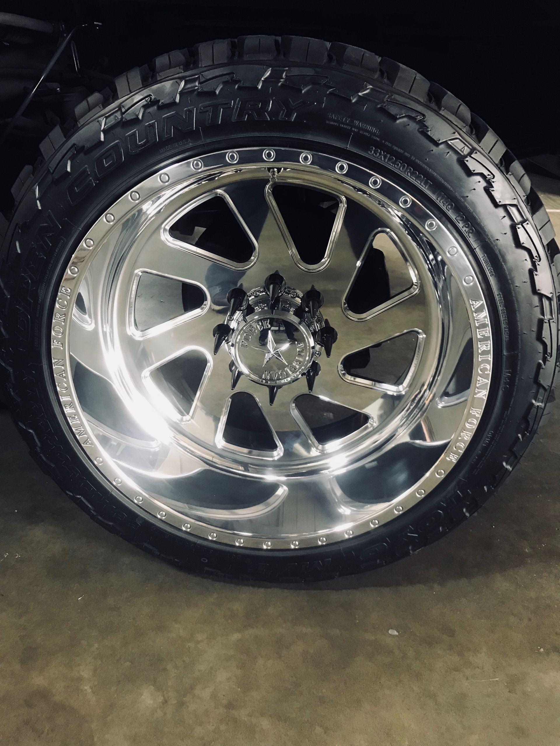 A close-up of a car wheel with a tire on it