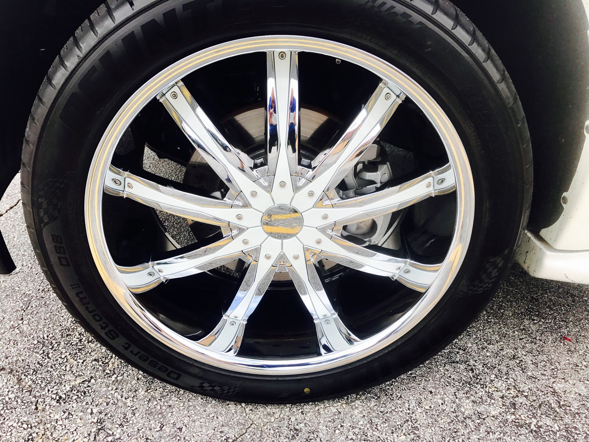 A close-up of a car wheel with chrome rims
